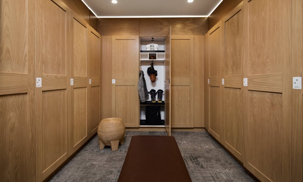 Private ski lockers with wood cabinetry and equipment storage at Limelight Residences Mammoth.
